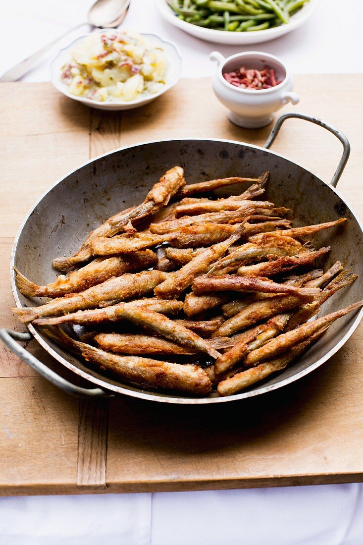 Fried smelts with a potato salad and beans