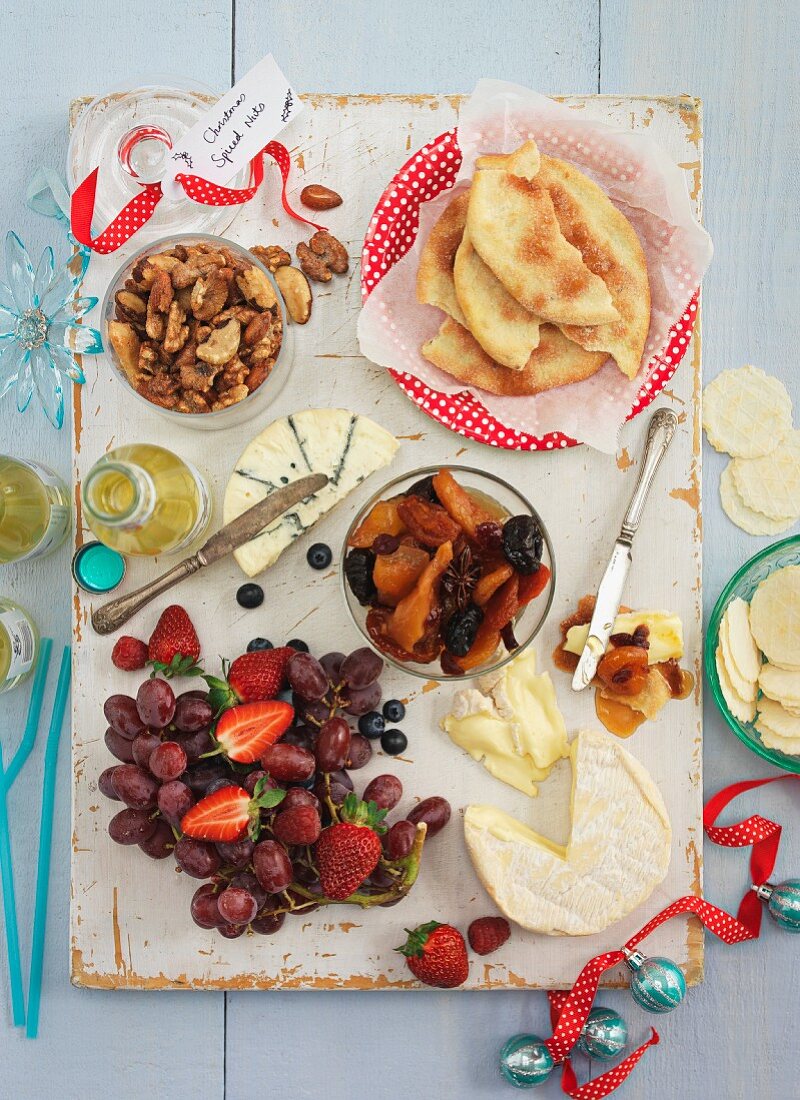 A cheese platter with fruit, nuts, compote and unleavened bread (Christmas)