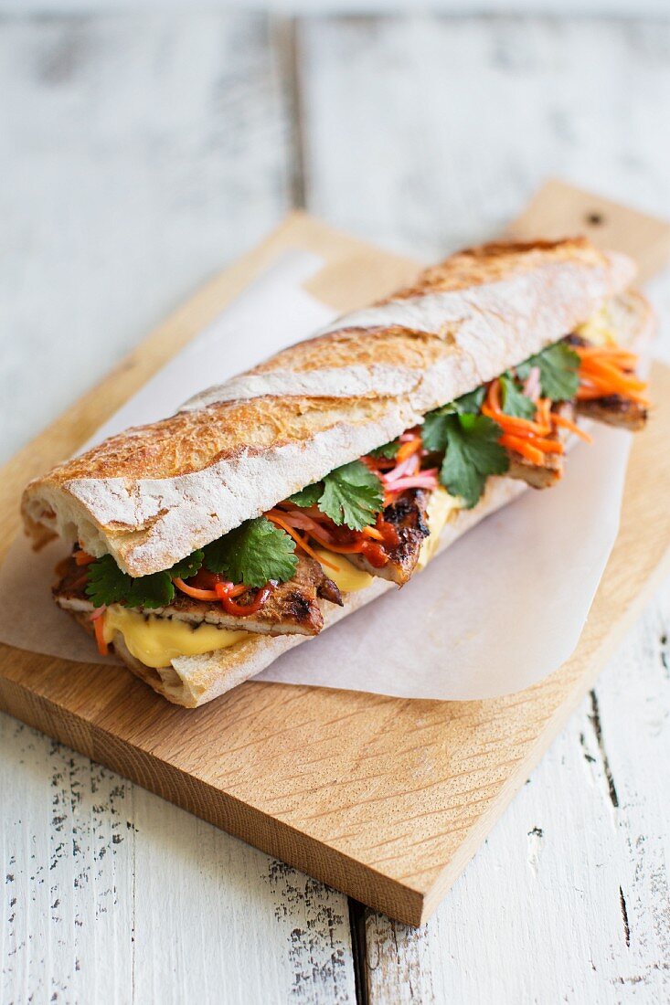 Banh Mi sandwich with pork, coriander, pickled carrots radishes and mayonnaise (Vietnam)