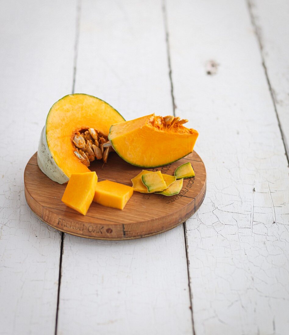 Sliced pumpkin on a wooden plate