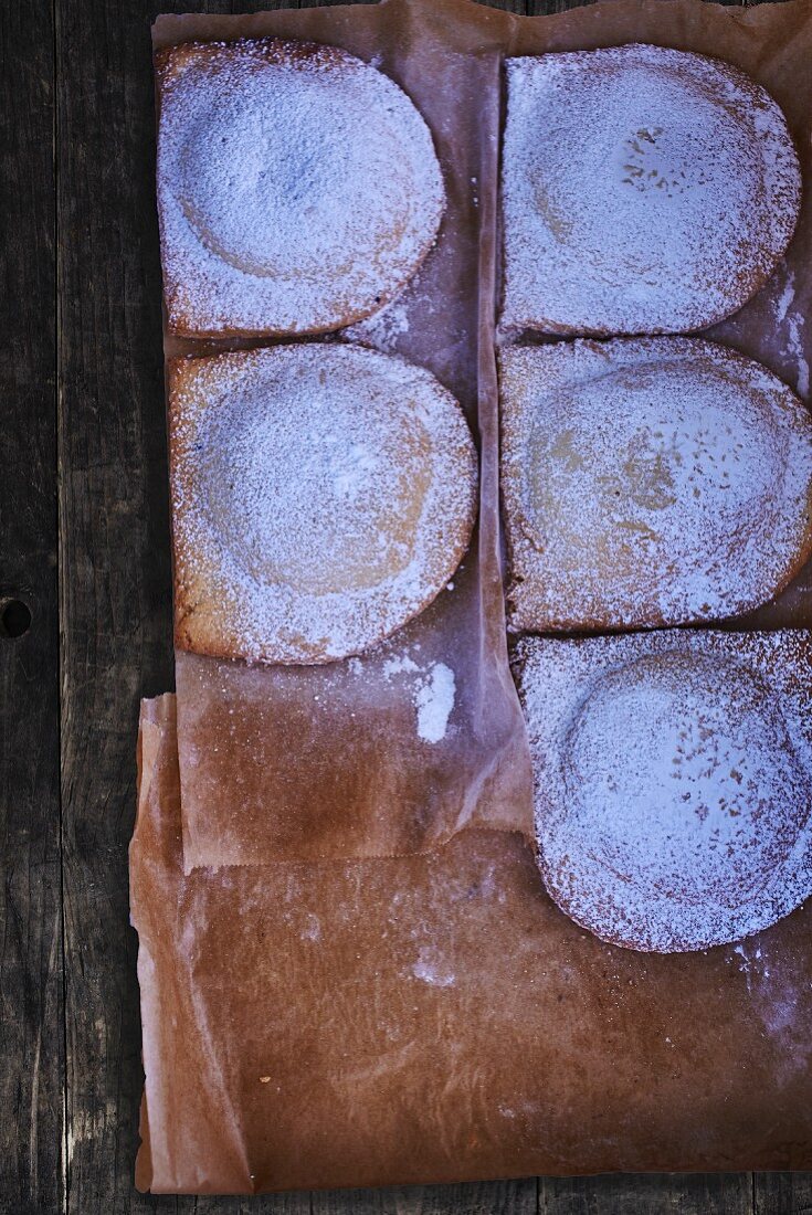 Chausson with icing sugar on a piece of baking paper