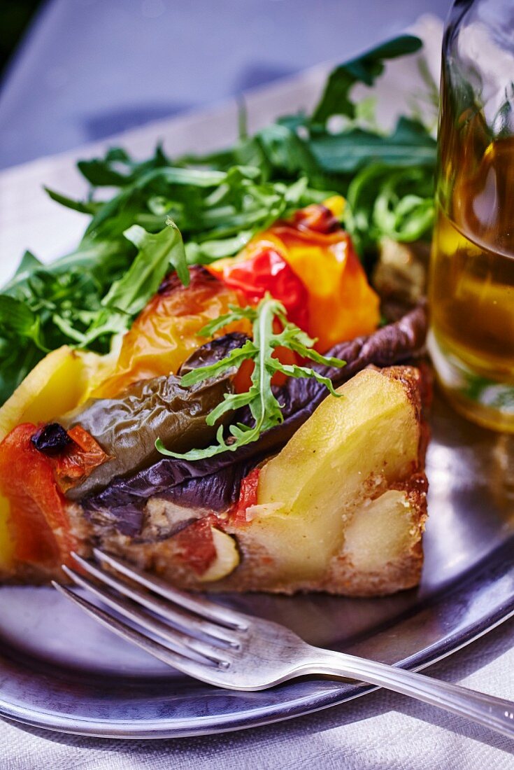 A portion of vegetable tart with potatoes and rocket