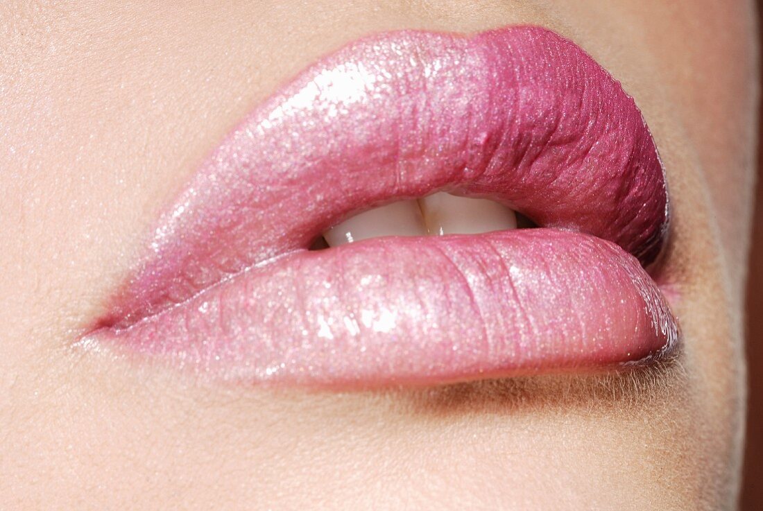 A woman's lips with pink lipstick, close-up