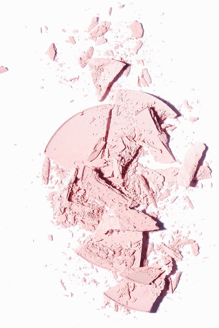 Powdered rouge crumbled on a white surface