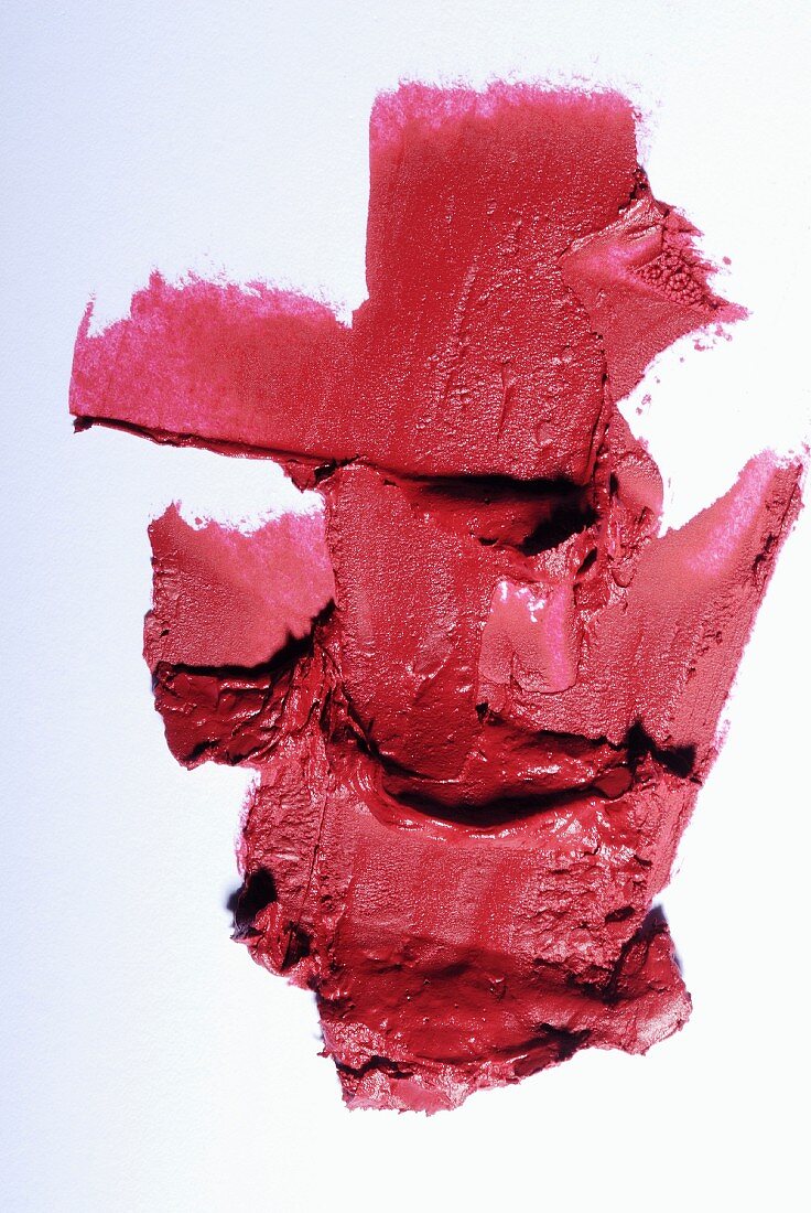 Old-rose lipstick on a white surface