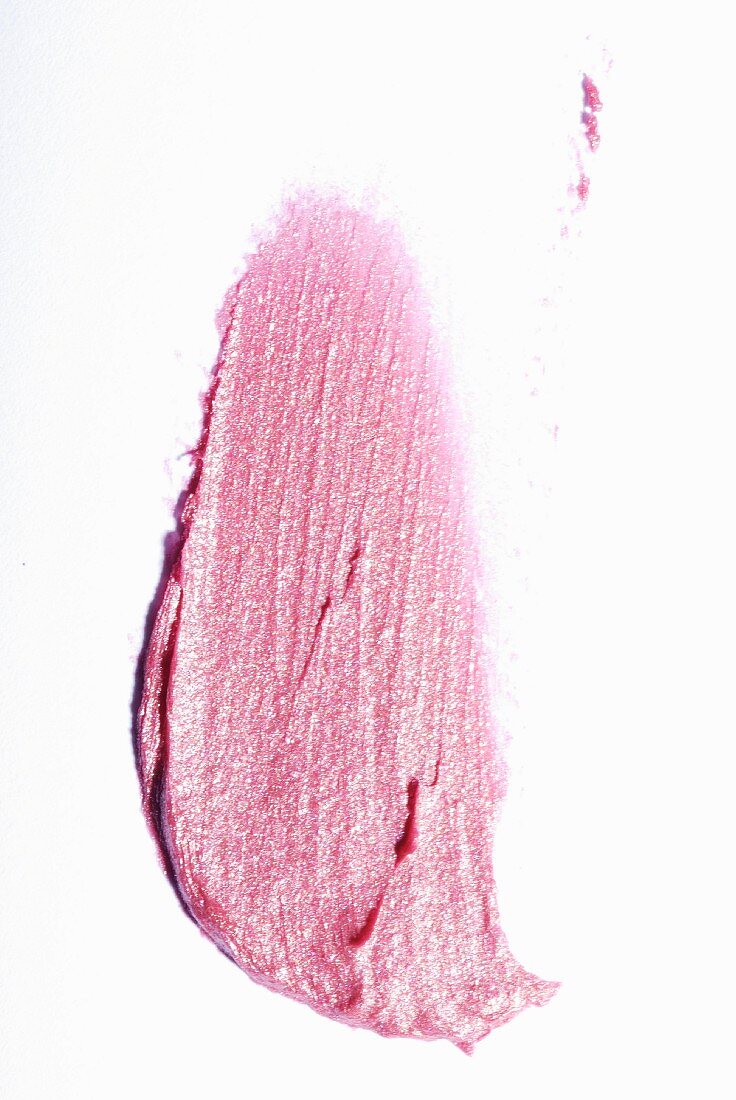 Pink lipstick on a white surface