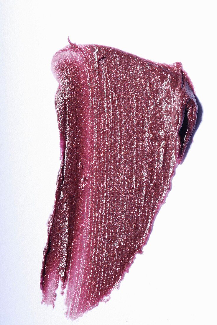 Old-rose lipstick on a white surface
