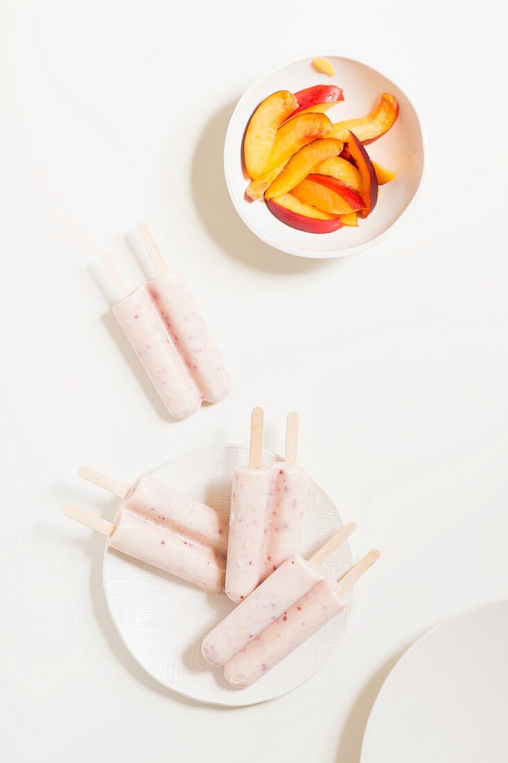 Peach ice lollies served with nectarine wedges