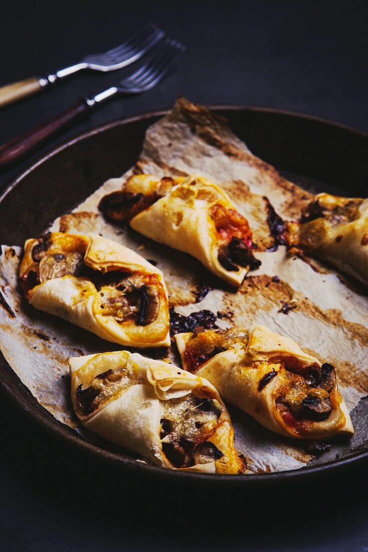 Puff pastries filled with bacon and mushrooms