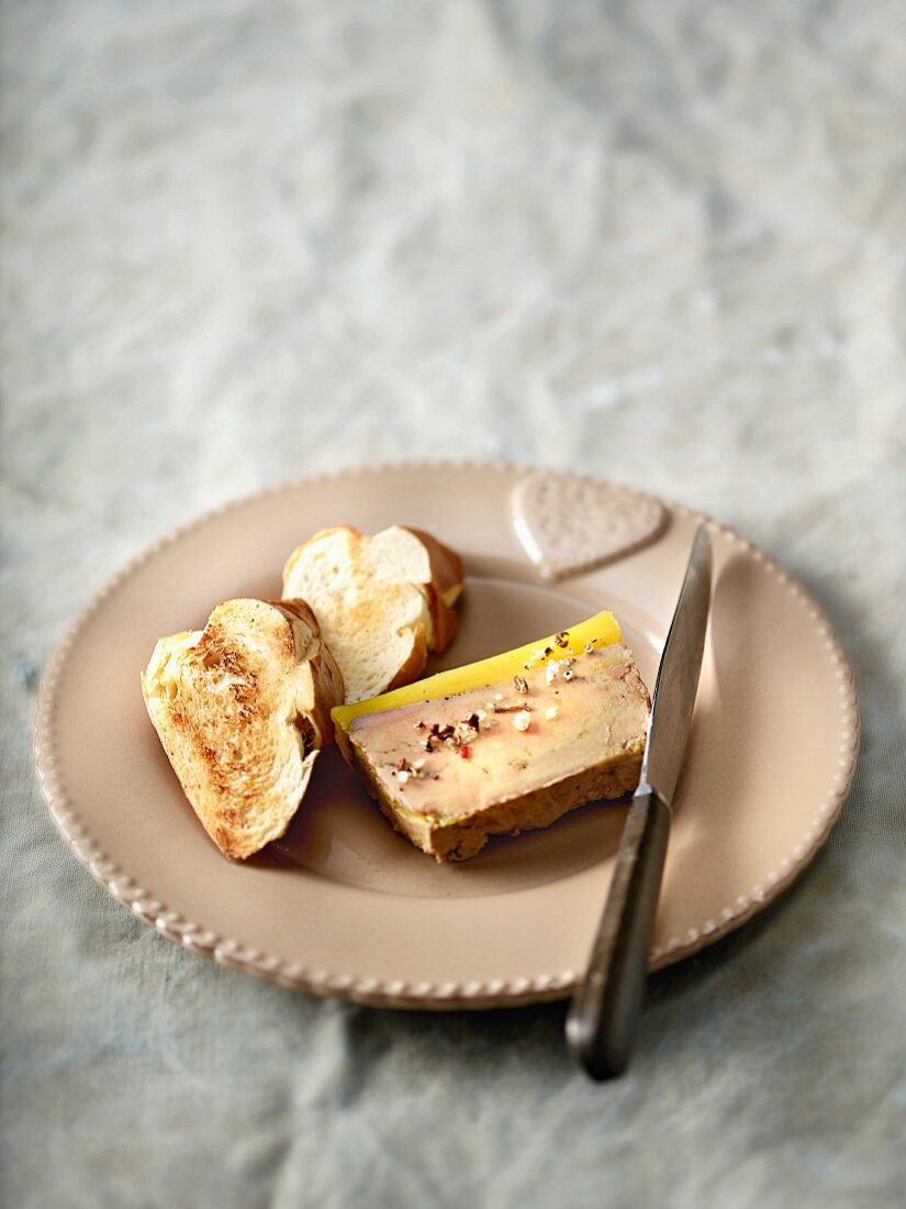 A slice of goose liver terrine with spices and brioche