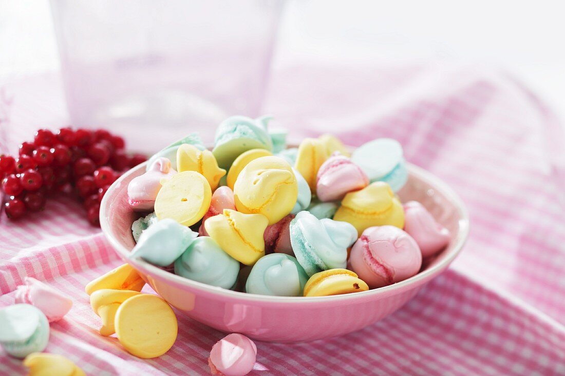 Colourful meringue dots in a pink bowl