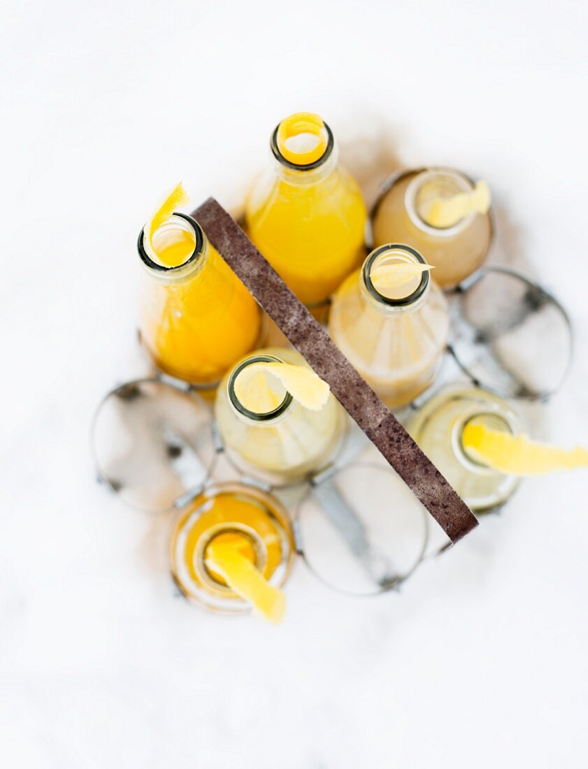 Bottles of lemonade in a bottle carrier in the snow (seen from above)