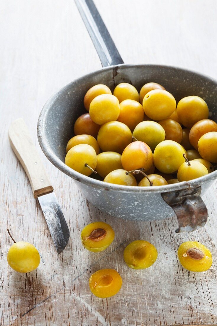 Yellow plums in a sieve