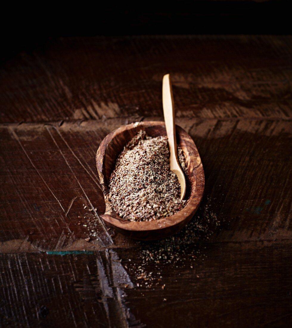 Ground flax seeds in a wooden dish