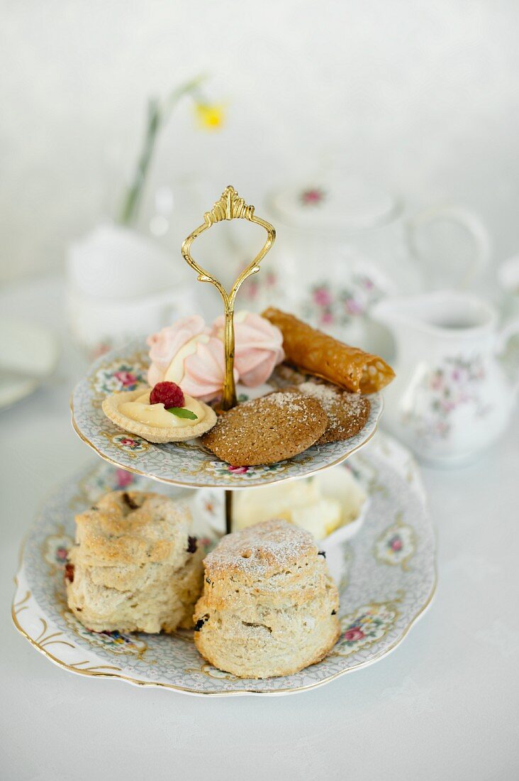 Scones and petit fours on a cake stand for afternoon tea