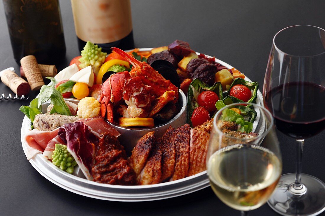 An appetiser platter served with wine