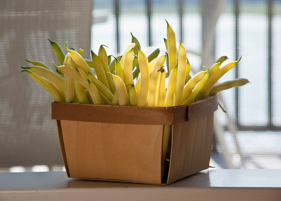 Yellow string beans in a wooden basket