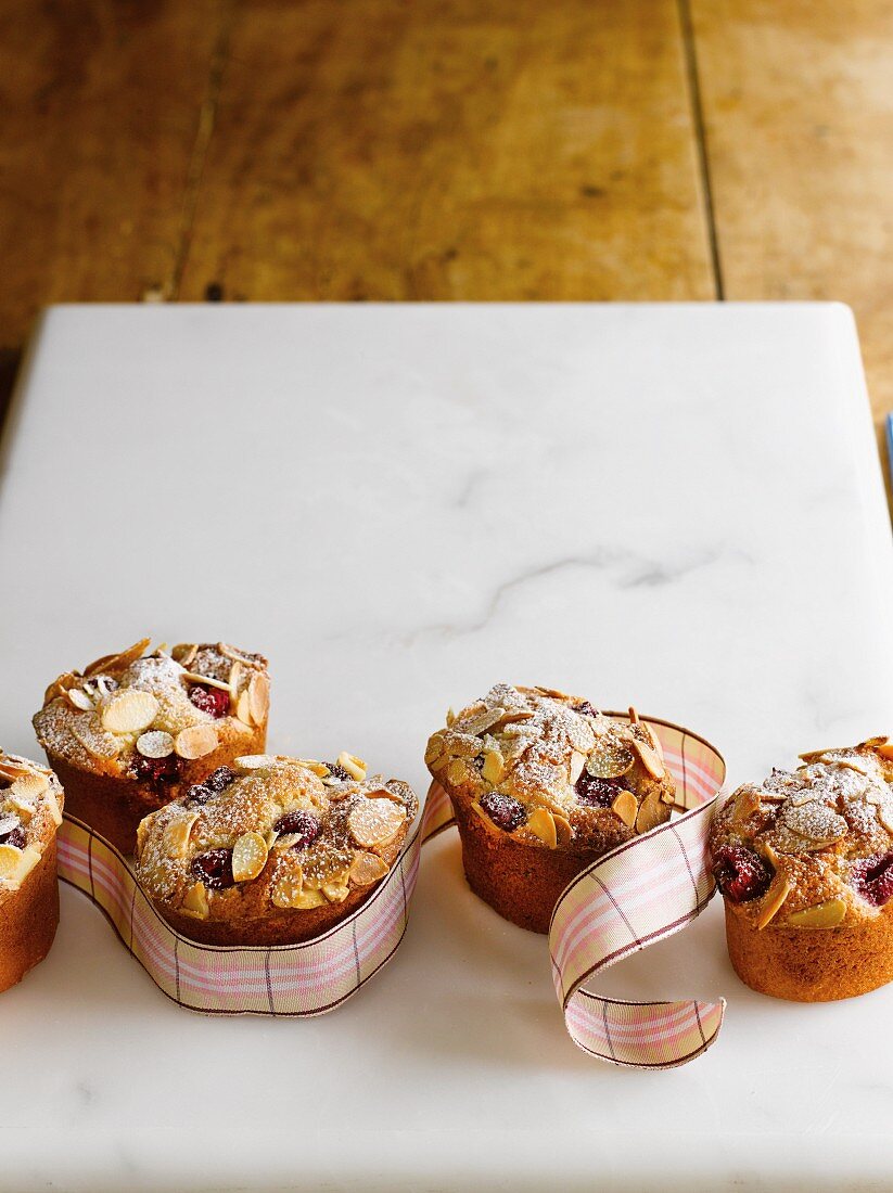 Friands with raspberries, lemons and flaked almonds as a gift