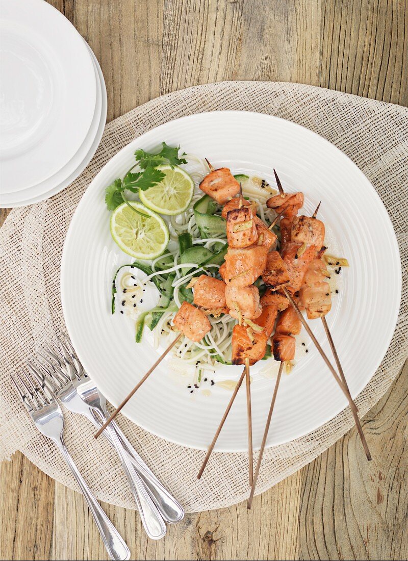 Salmon skewers on a rice noodle salad