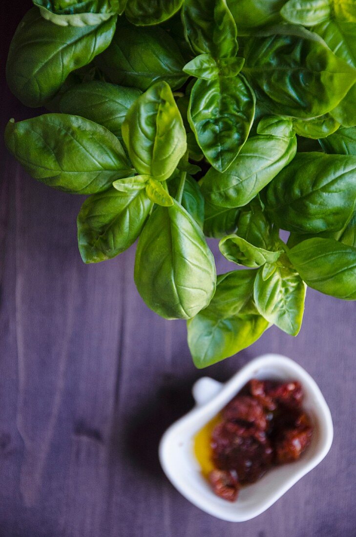 Fresh basil and dried tomatoes in olive oil