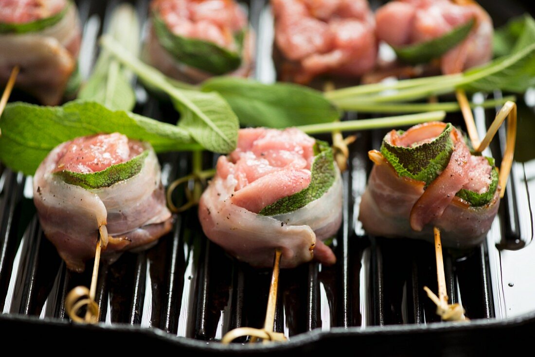Chicken and sage skewers on a grill