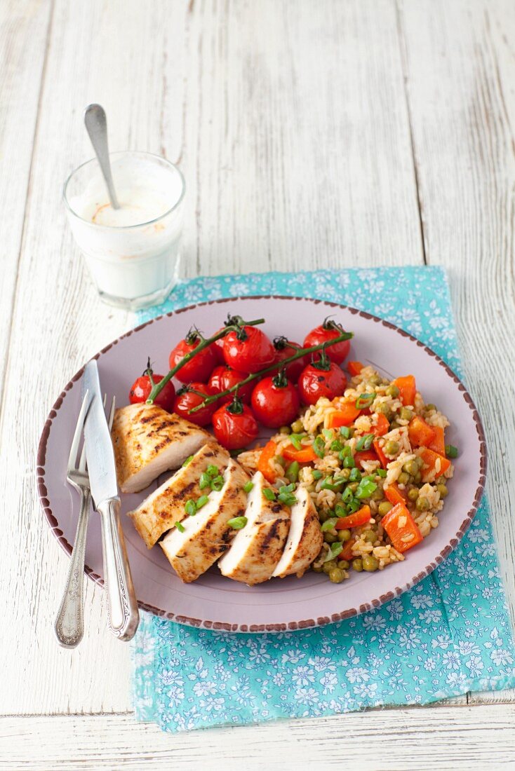 Grilled chicken breast with a rice, peppers and pea salad