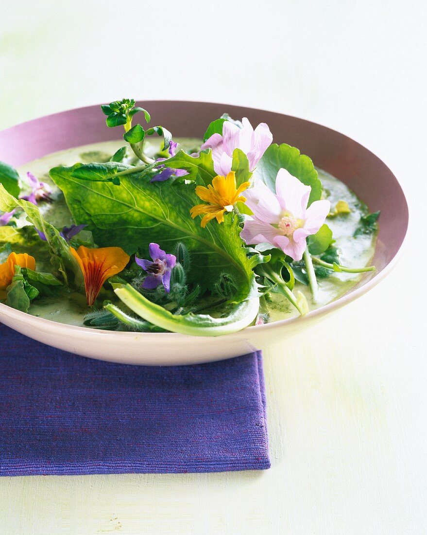 Green gazpacho with fresh herbs and edible flowers