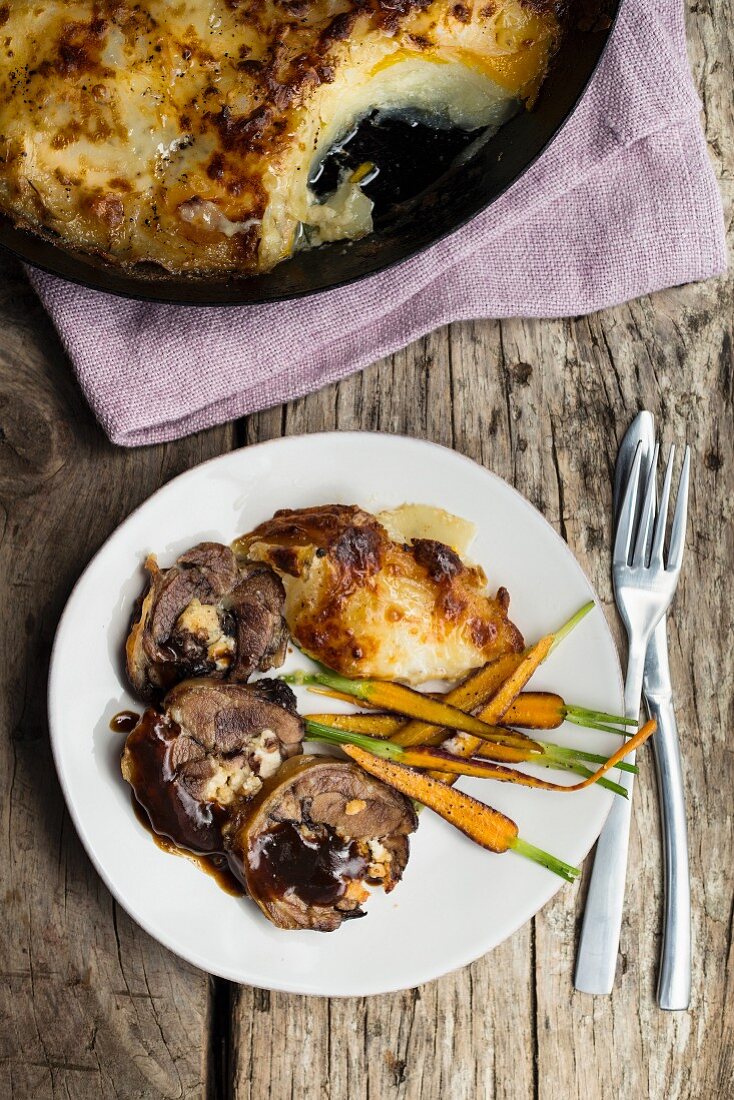 Grilled karoo lamb collar filled with goat's cheese and pine nuts with a potato and mozzarella gratin and carrots