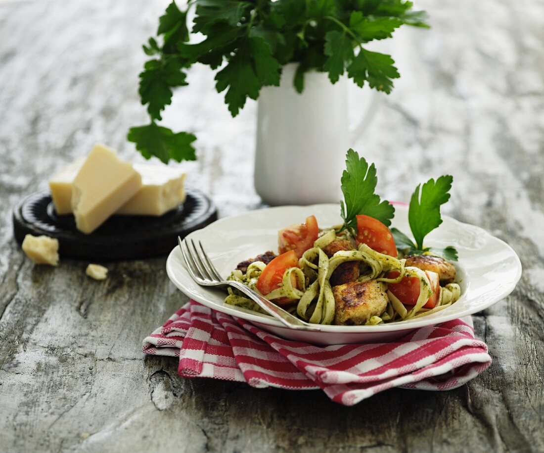 Tagliatelle with parsley pesto, tomatoes and meatballs