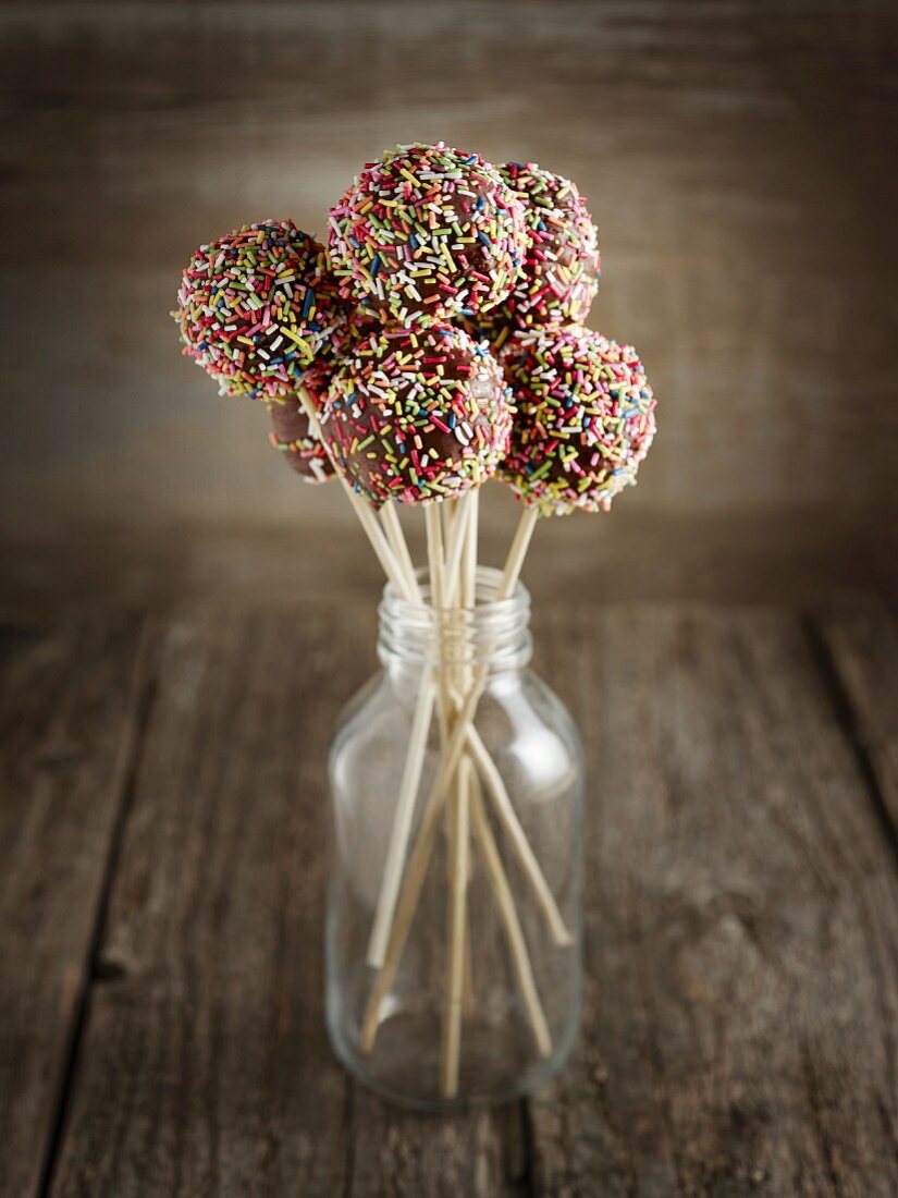 Chocolate cake pops decorated with colourful sugar sprinkles
