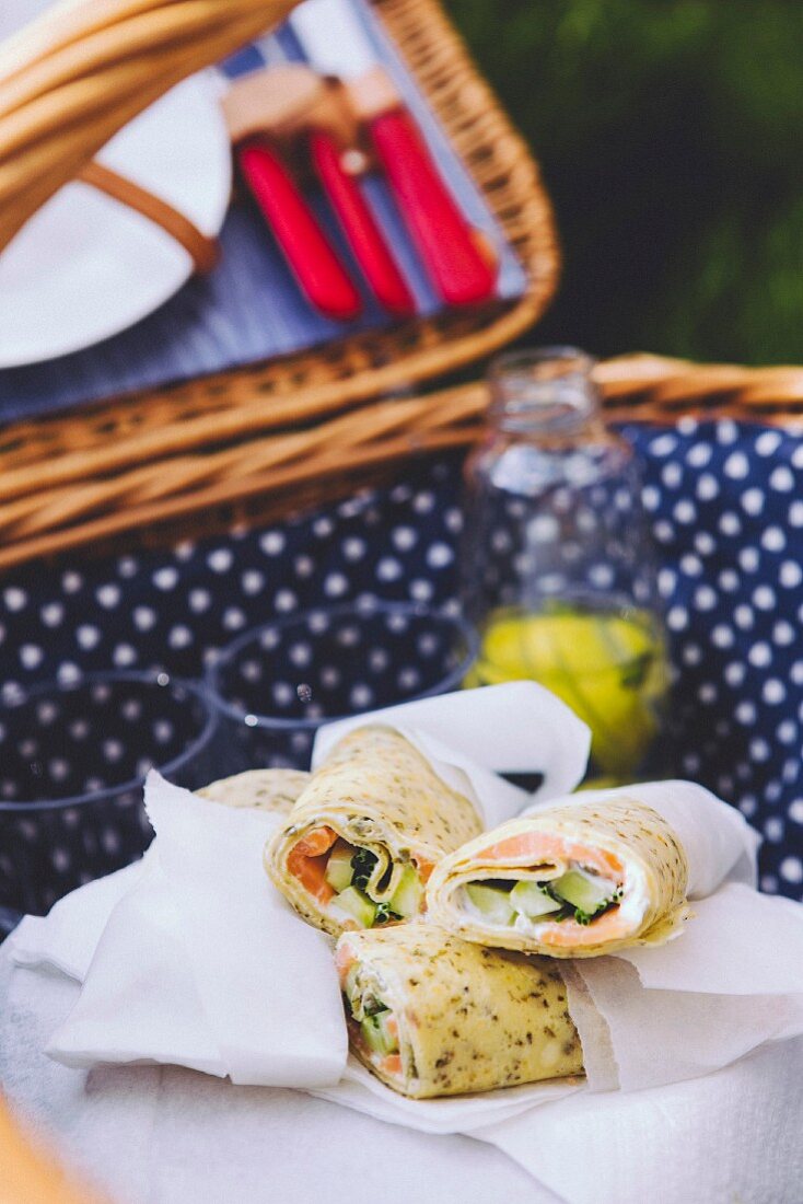 Salmon and cucumber wraps in a picnic basket