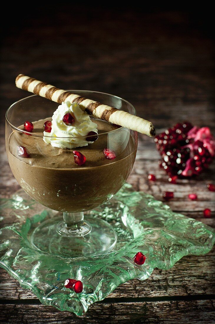 Chocolate cream with whipped cream and pomegranate seeds