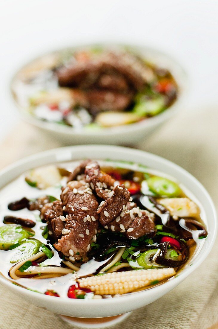 Oriental beef broth with mushrooms, chillis and sesame seeds