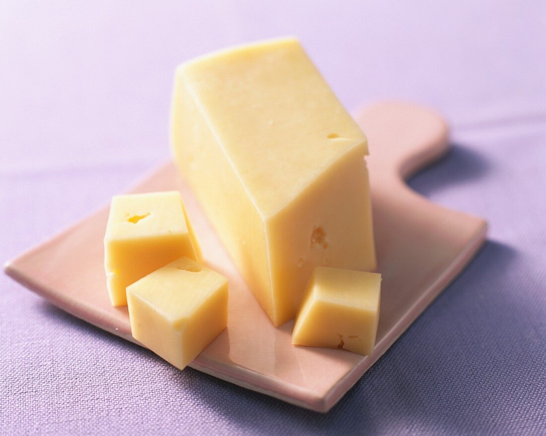 Butter cheese on a chopping board