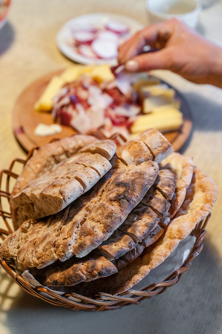 Homemade bread (crispy unleavened bread from South Tyrol) with bacon and cheese