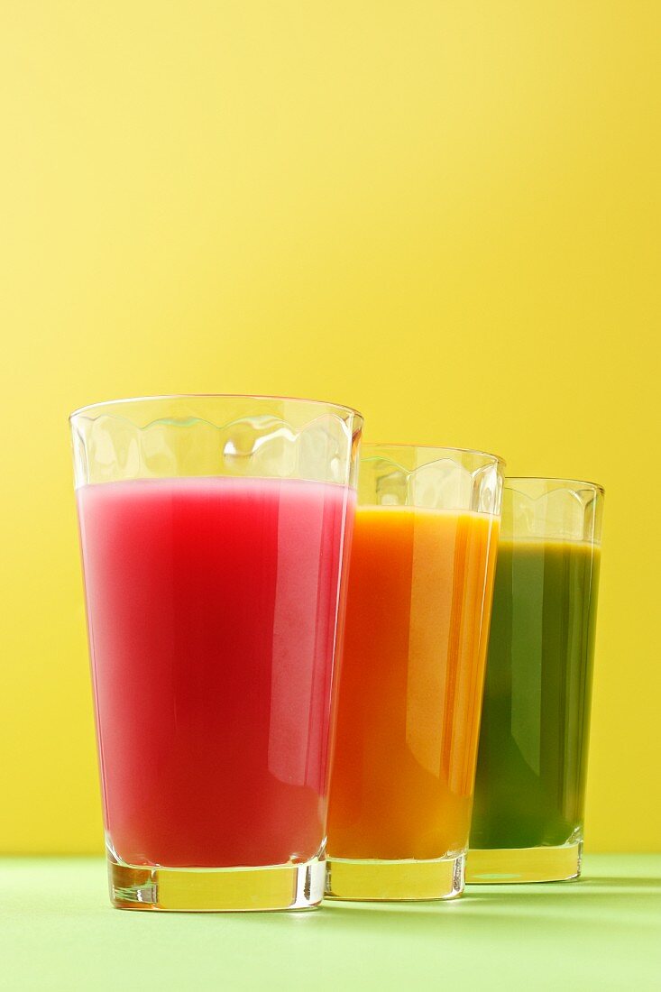 A row of three different coloured smoothies