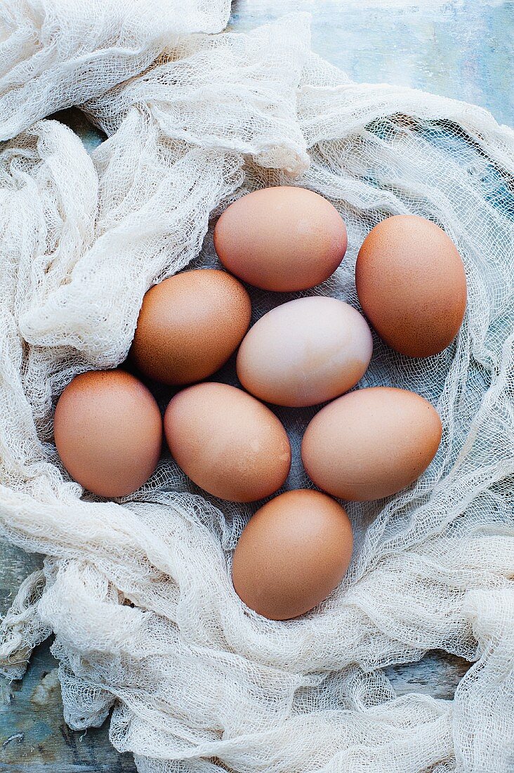 An arrangement of organic eggs on a muslin cloth