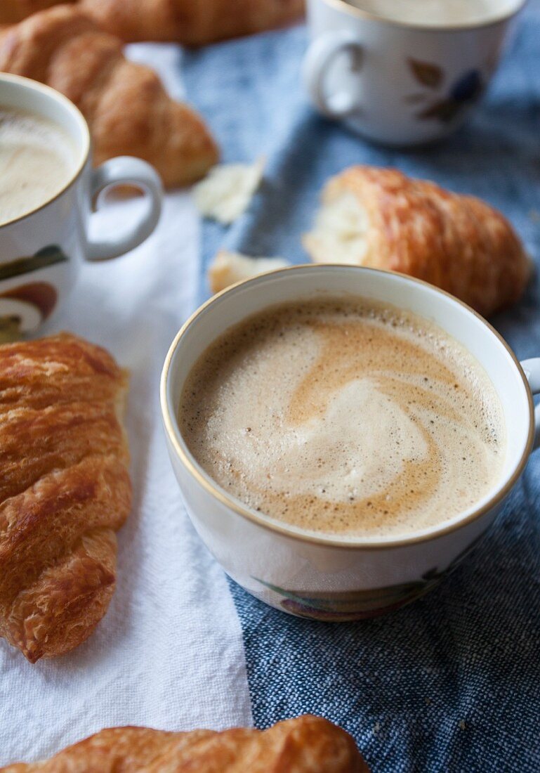 Kaffee und Croissants auf Frühstückstisch