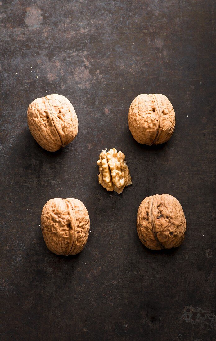 Four whole walnuts and one shelled