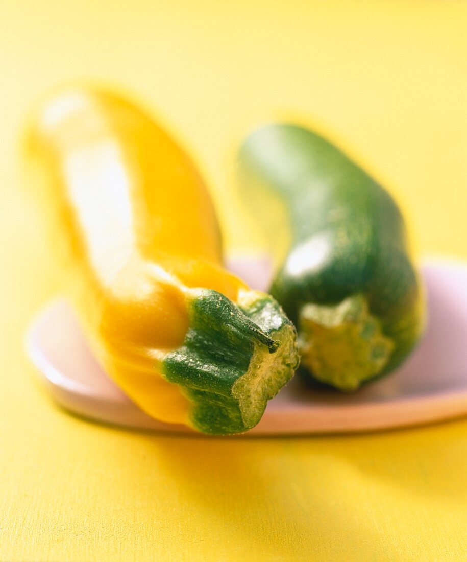 Yellow and green courgettes on a ceramic board