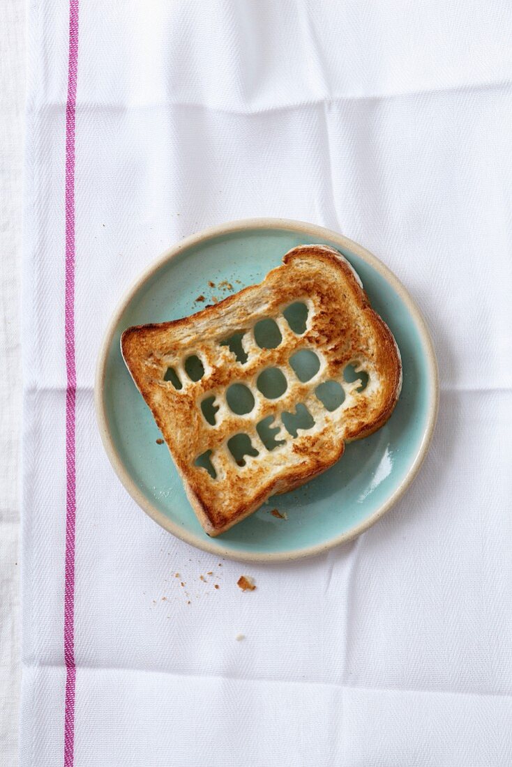 A slice of toast with letters cut out of it (10 Top Food Trends)