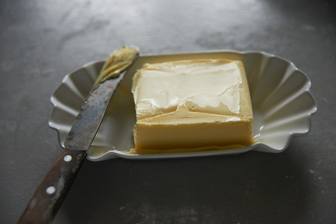 Butter in a ceramic dish with an old knife