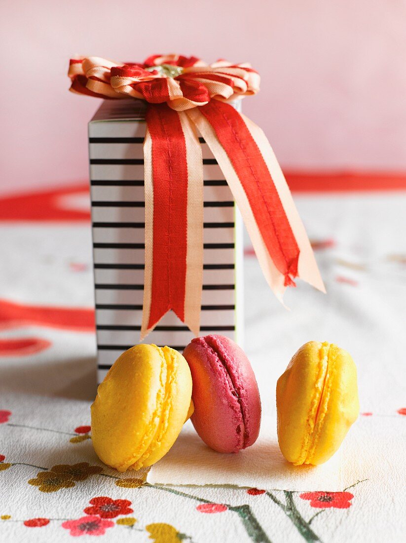 Macaroons in front of a decorative gift box