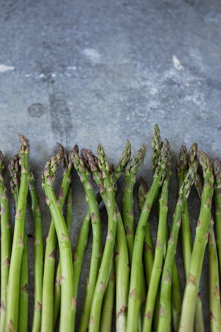 Fresh green asparagus on a metal surface