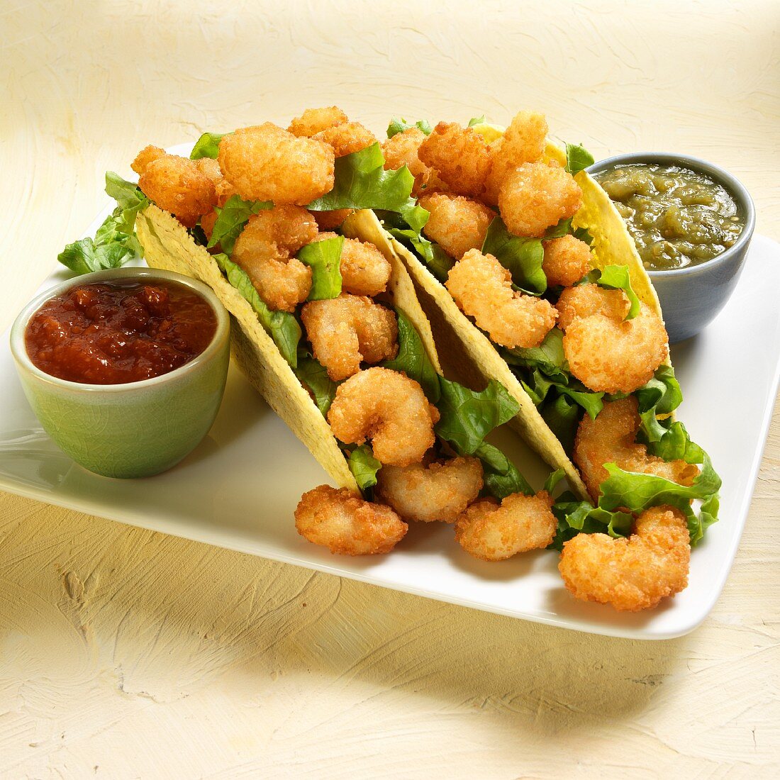 Tacos with battered prawns, tomatillo sauce and chili sauce