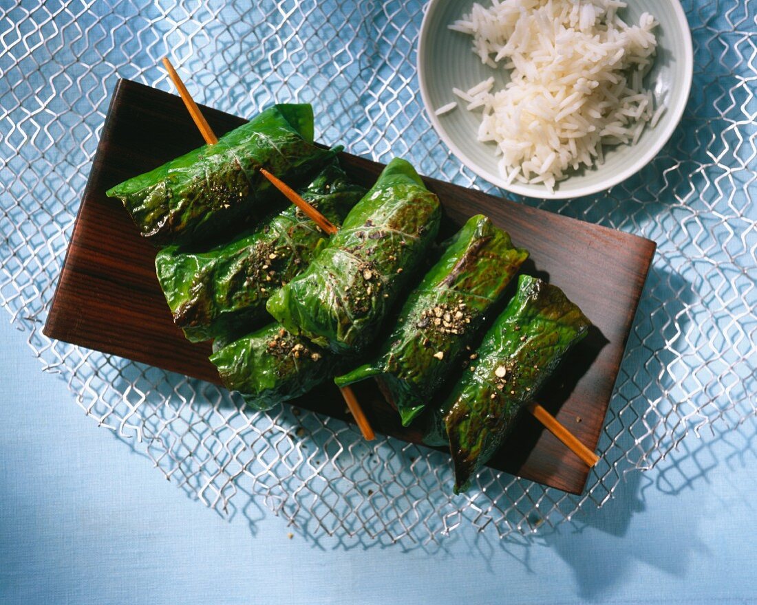 Beef wrapped in pepper leaves on a stick