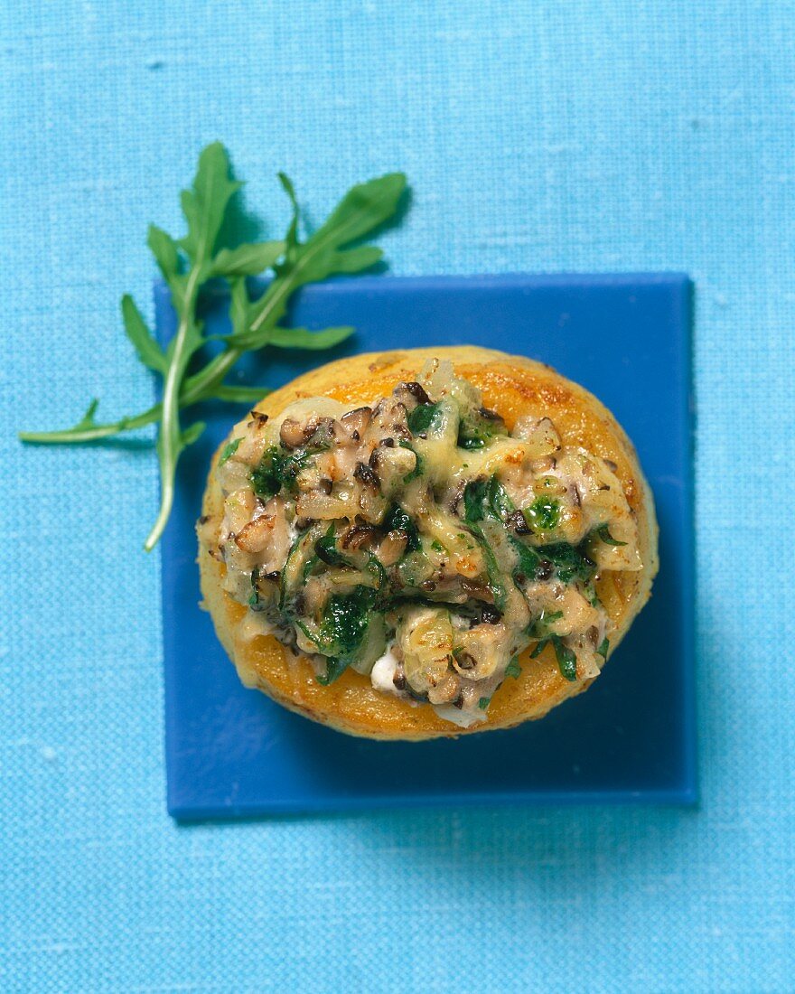 A gratinated potato with a rocket and mushroom filling