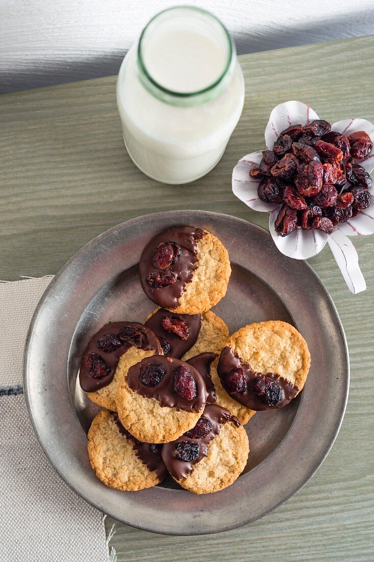 Chocolate-dipped oat biscuits and dried cranberries
