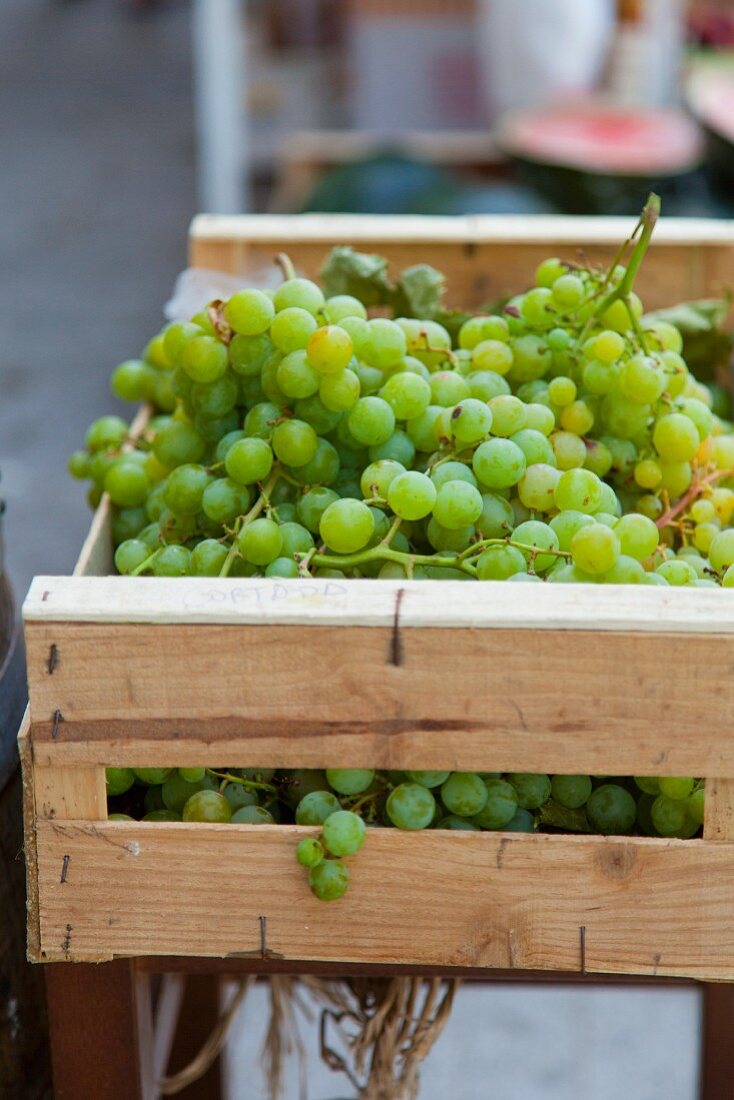 Green grapes in a wooden crate