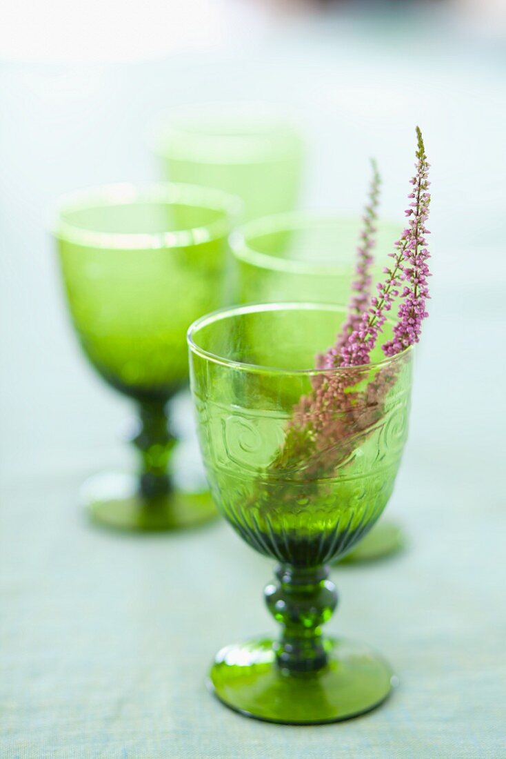 Sprigs of heather in green, stemmed glasses